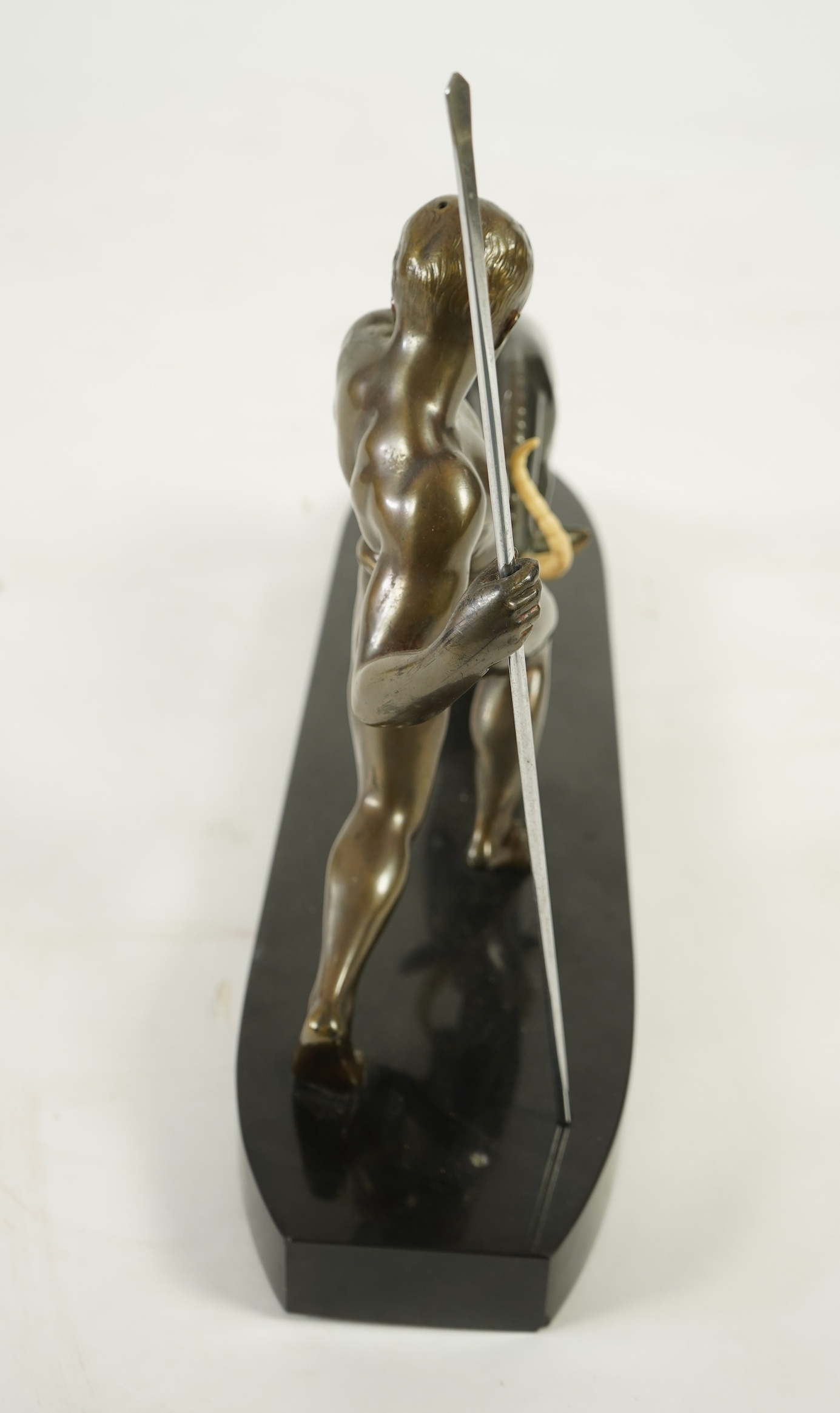 Attributed to Zoltan Kovasz (Romanian, 1883-1952), a bronzed spelter male hunter holding a chromed spear, with springbok, on a polished slate base